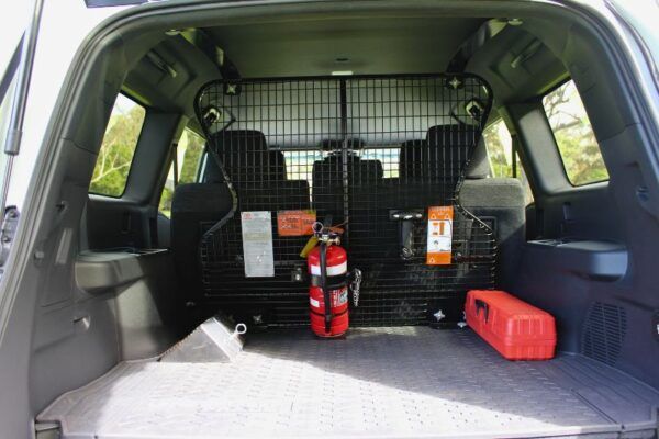 Inside of a Prado 250 Series Boot with fire extinguisher, wheel chocks and safety triangles