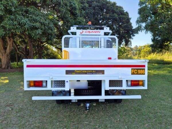Rear shot of Isuzu tray back truck