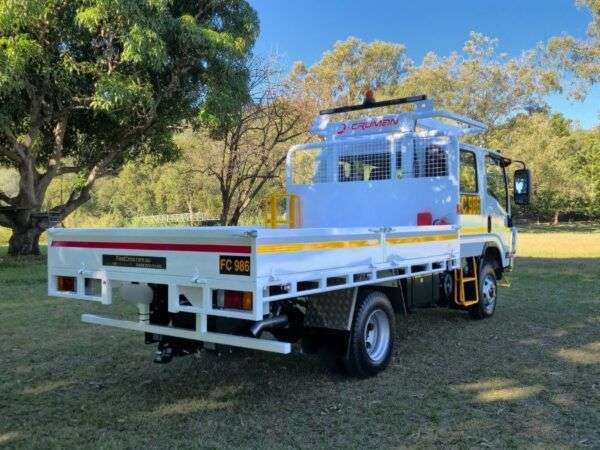 Rear corner of white mine spec Isuzu tray back truck