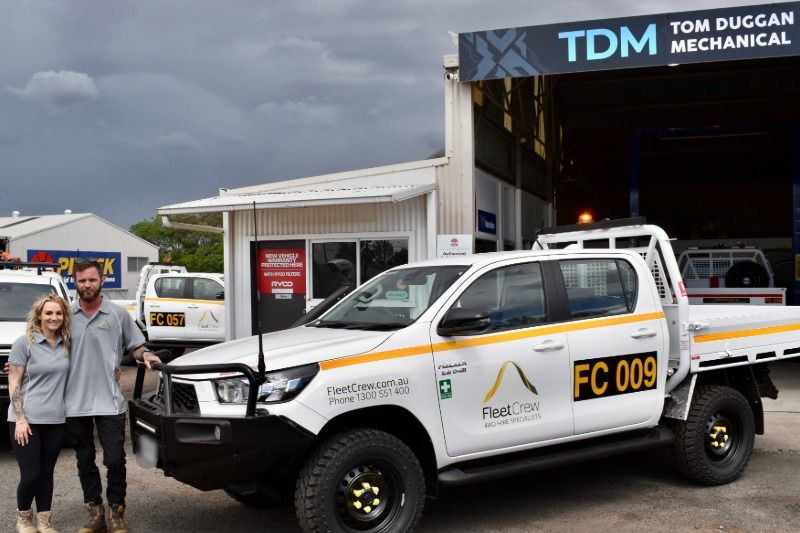 FleetCrew's Dubbo Managers Alana and Tom standing with FleetCrew Hilux