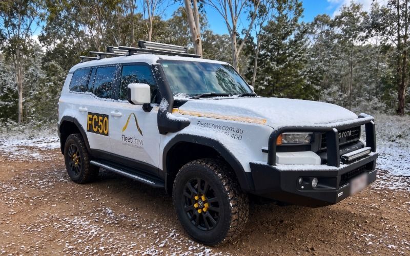 FleetCrew Prado 250 parked in a snowy clearing